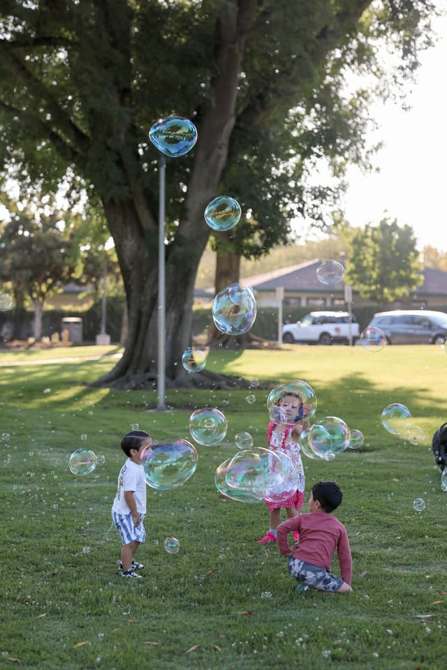 Kids reaching for bubbles